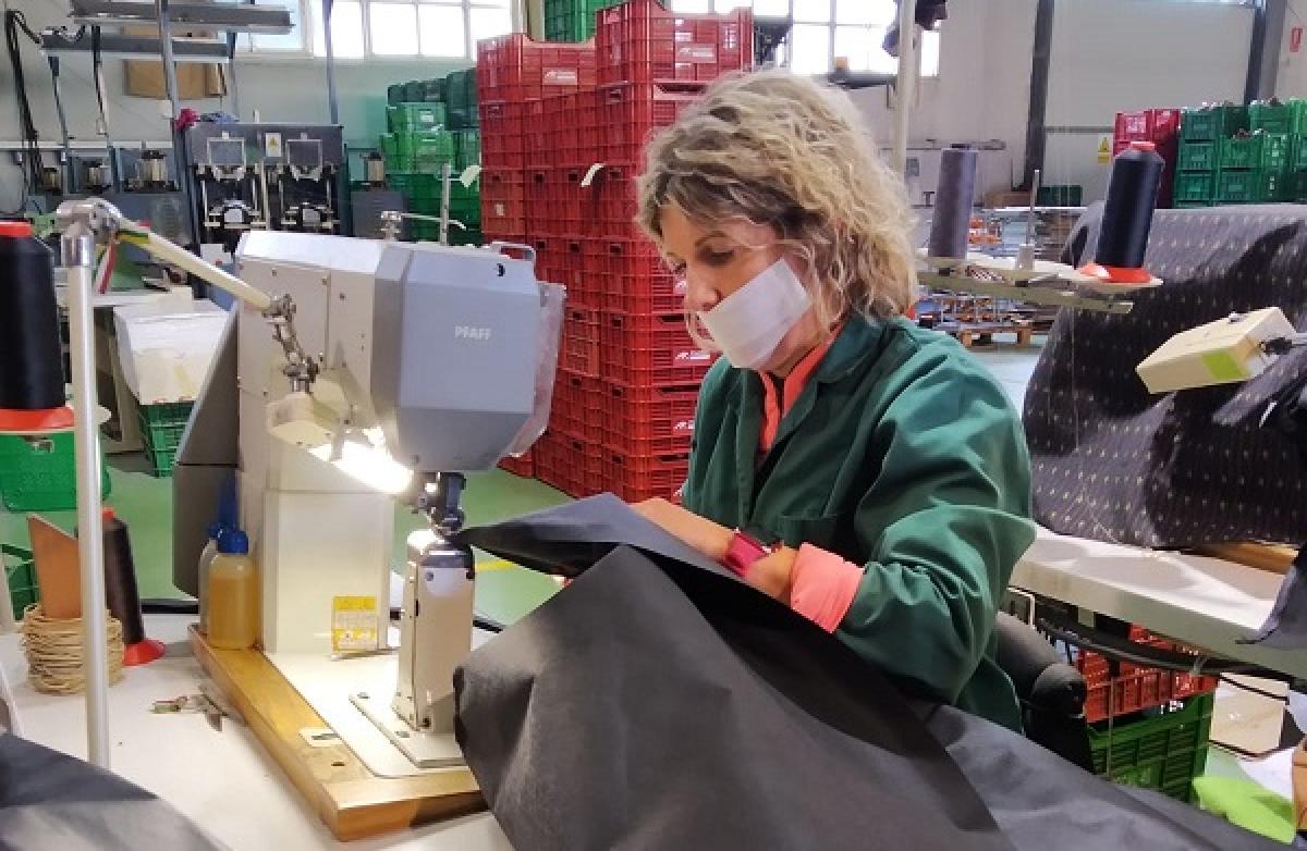 Trabajadora de la industria del calzado riojana cose el primer proyecto de bata sanitaria